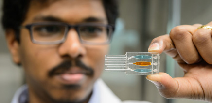 close up of biomedical engineer looking at micro chip