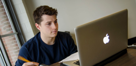 UConn engineering working on apple laptop.