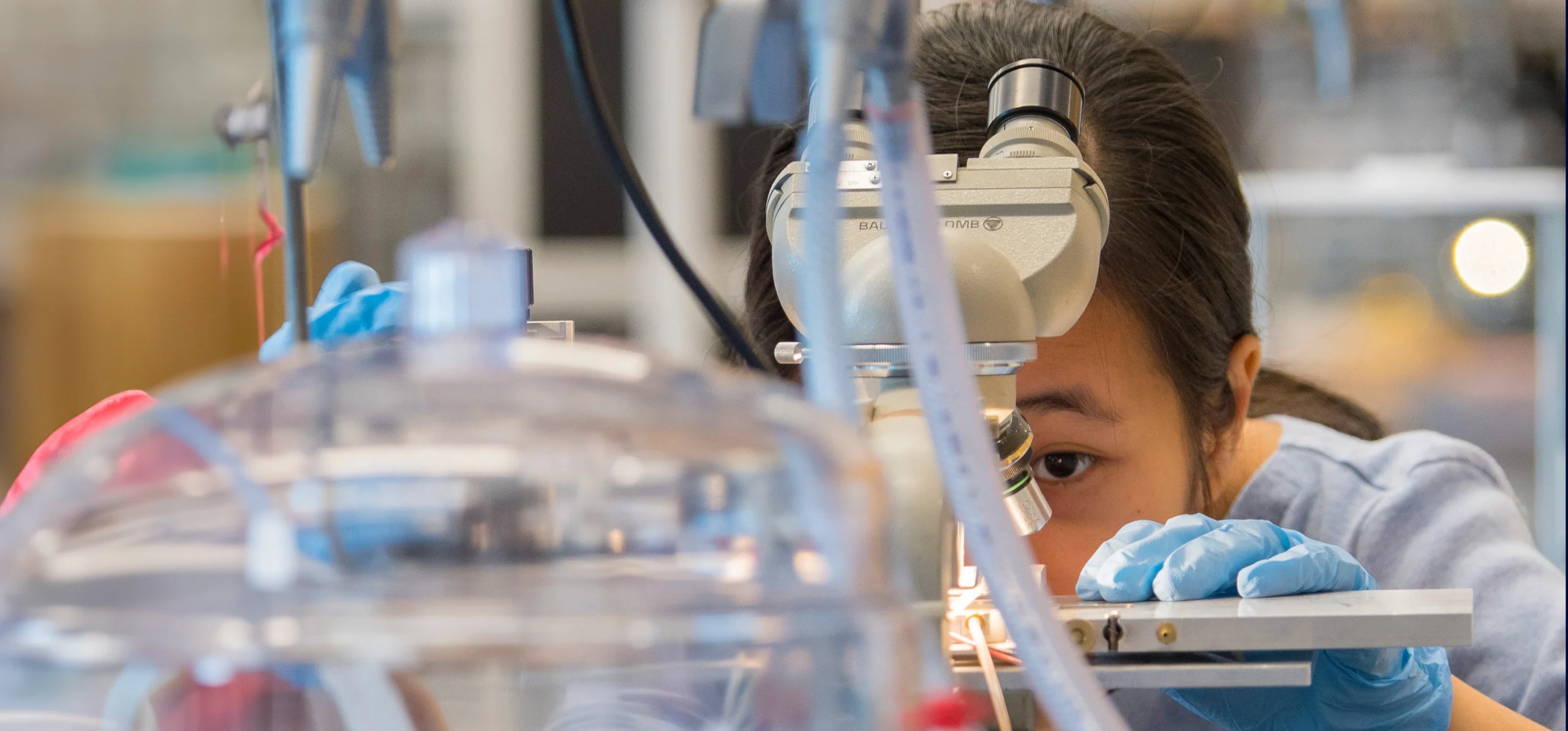 Close up of UConn Chemical Engineering student working in lab.