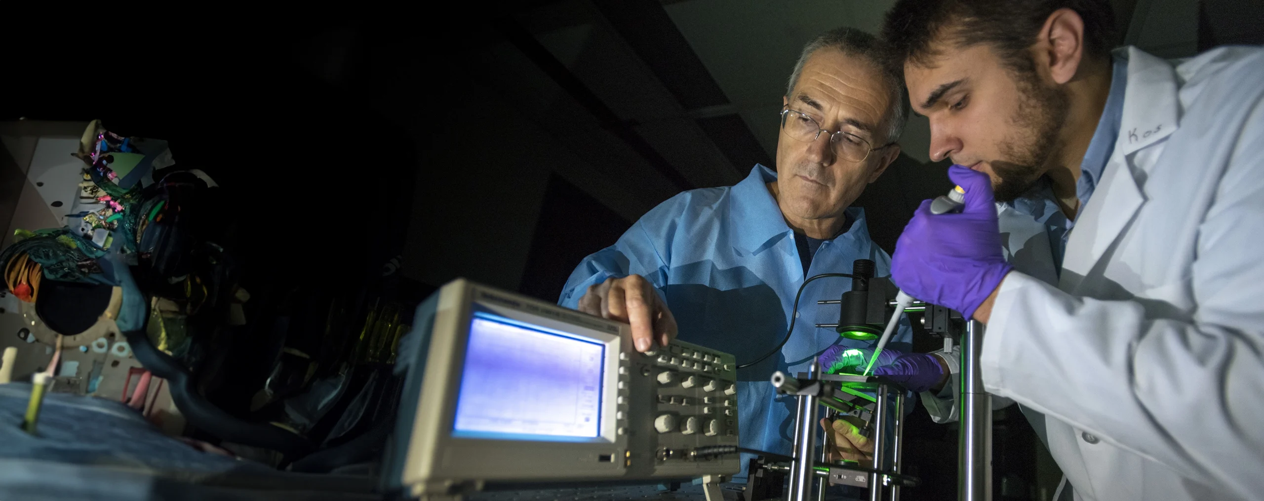 Mechanical engineering profesor George Lykotrafitis with student Kostyantyn Partola demonstrating their whole blood rheometer technology.