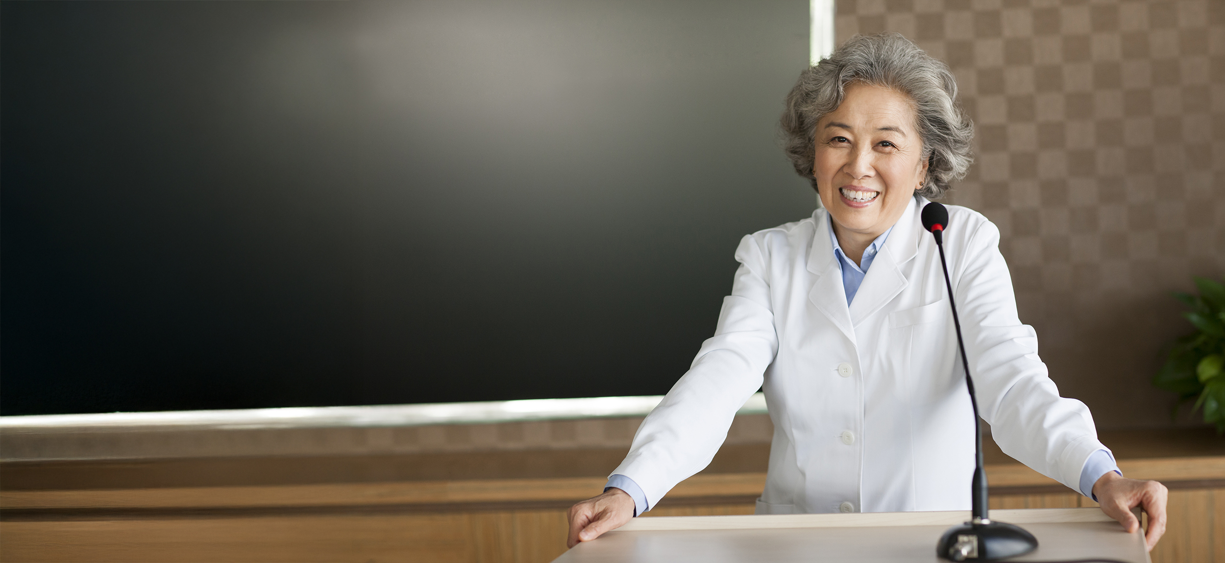 Senior female Chinese doctor giving a speech